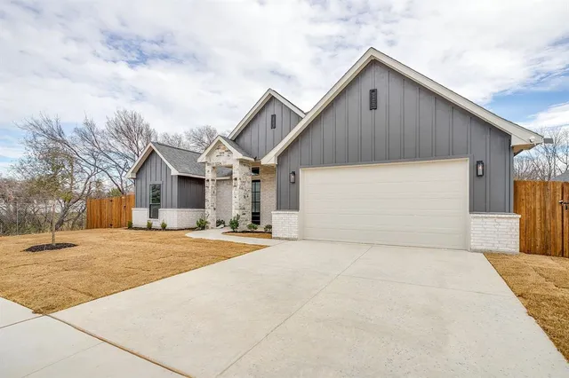 a view of garage yard and front view of house