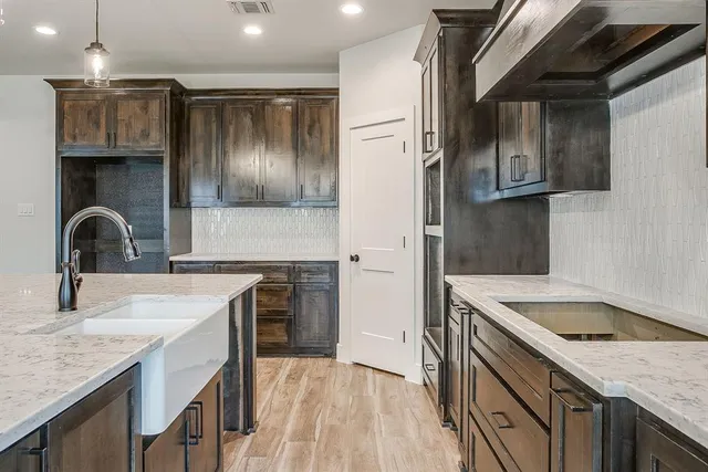 a kitchen with a sink and a refrigerator