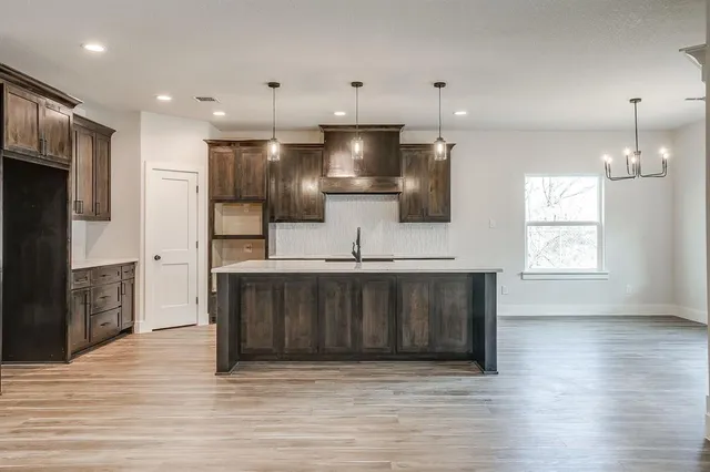 a kitchen with a sink stainless steel appliances and cabinets