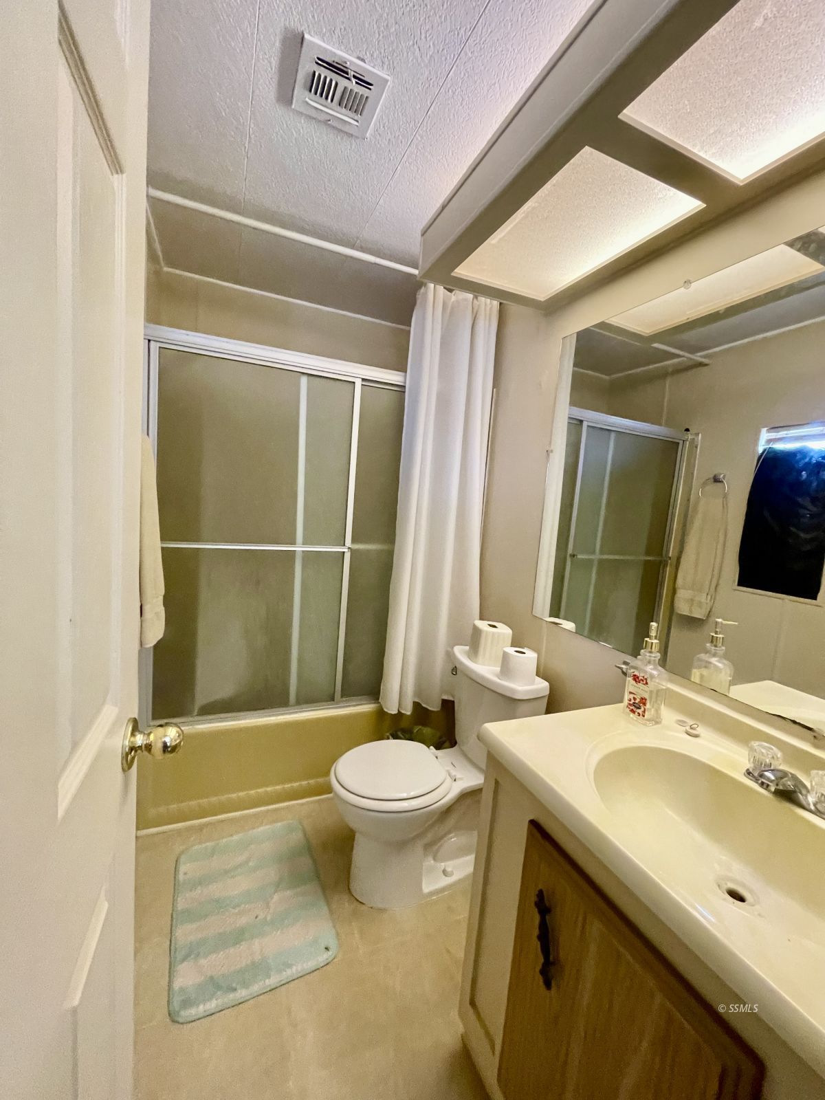 5237 Nolina Avenue Ridgecrest, CA 93555 - Photo 17 of 27 a bathroom with a sink a toilet and shower