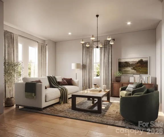 a living room with furniture and a chandelier