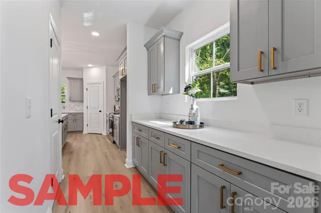 a kitchen with a sink stove and cabinets