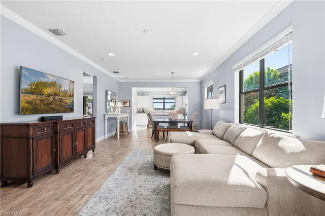 a kitchen with granite countertop a center island stainless steel appliances cabinets and a window