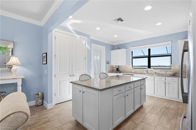 a bathroom with a granite countertop double vanity sink a mirror and a