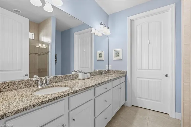 a bathroom with a sink a toilet a mirror and shower curtain