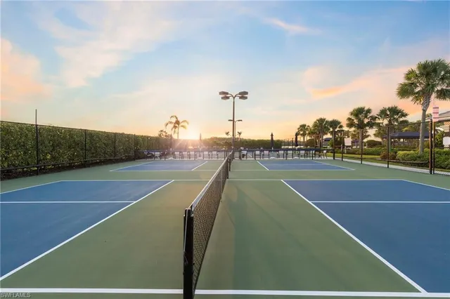 a view of tennis court with houses
