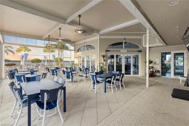 a view of a patio with couches and table and chairs and potted plants