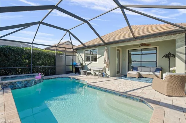 an aerial view of residential houses with outdoor space and swimming pool