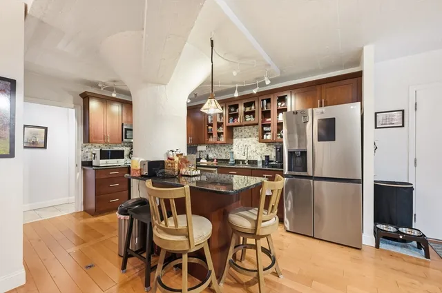 a kitchen with stainless steel appliances granite countertop a stove and a sink