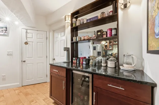 a bathroom with a granite countertop sink toilet a mirror a bathtub and shower