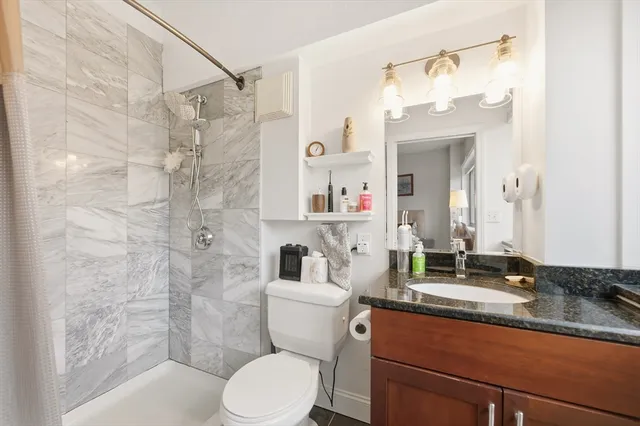 a bathroom with a sink toilet and shower