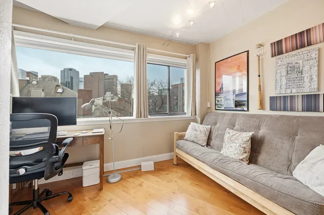 a view of a workspace with furniture and a window