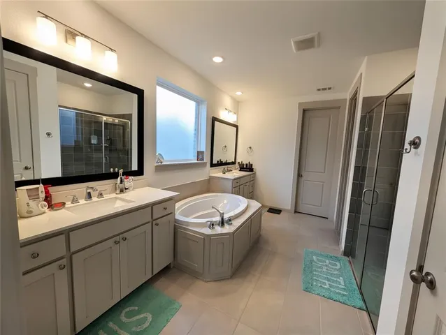 a bedroom with furniture and a flat screen tv