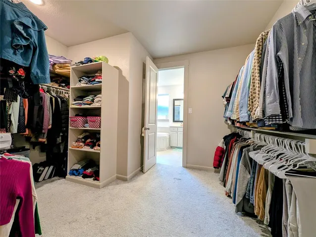 a bathroom with a double vanity sink mirror and bathtub