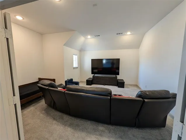 wooden floor and view of kitchen and windows