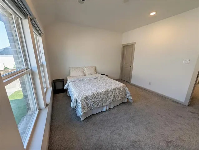 an empty room with fireplace and windows