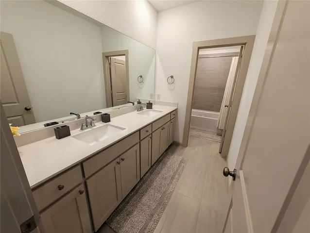 a bedroom with a bed and a mirror