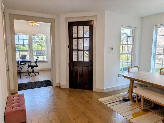 a livingroom with lounge chair and windows