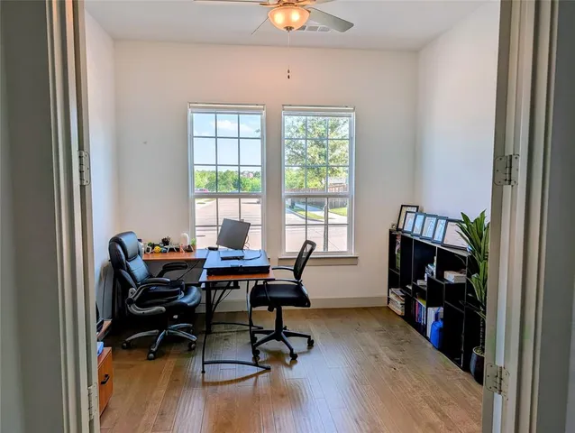 a view of a workspace with furniture and a window