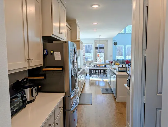 a kitchen with a refrigerator a stove and a sink
