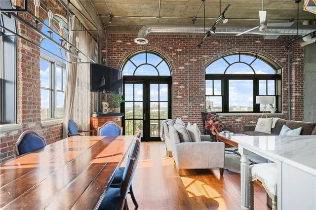 a living room with couches a coffee table and a large with kitchen view