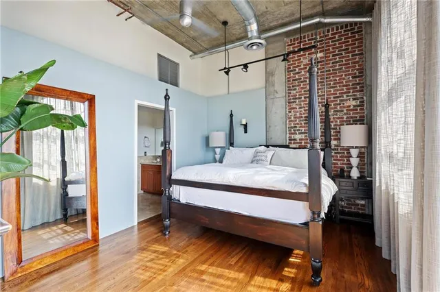 a bedroom with a bed and a mirror