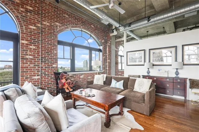 a living room with furniture and a chandelier
