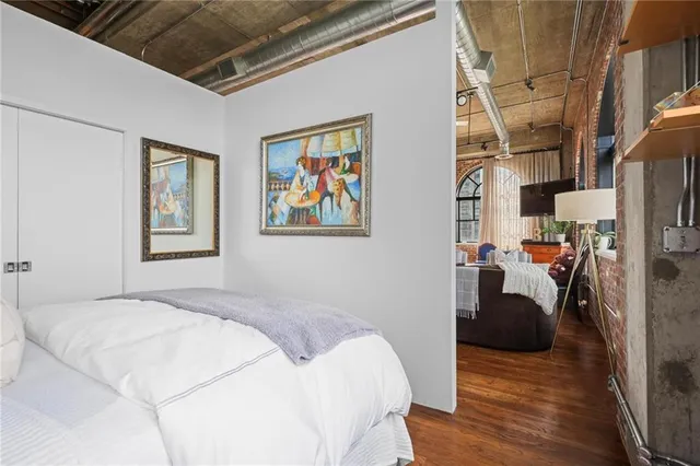 a bedroom with a bed couch and a window