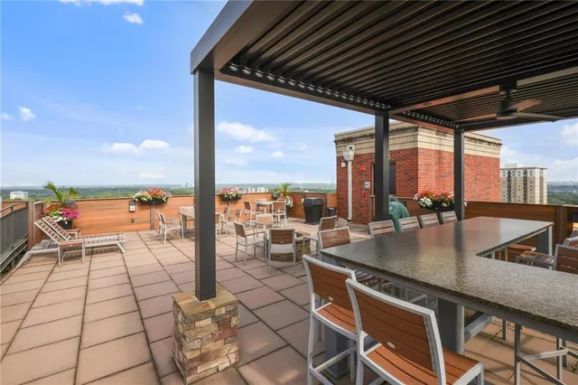 a living room with furniture and a kitchen view
