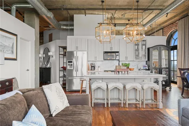 a white kitchen with a sink and refrigerator