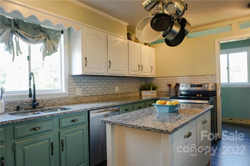 516 Starview Drive Rutherfordton, NC 28139 - Photo 27 of 47 a kitchen with a sink a cabinets and window