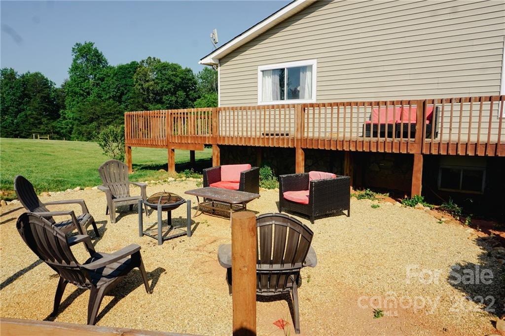 516 Starview Drive Rutherfordton, NC 28139 - Photo 7 of 47 a view of a patio with table and chairs with wooden floor and fence