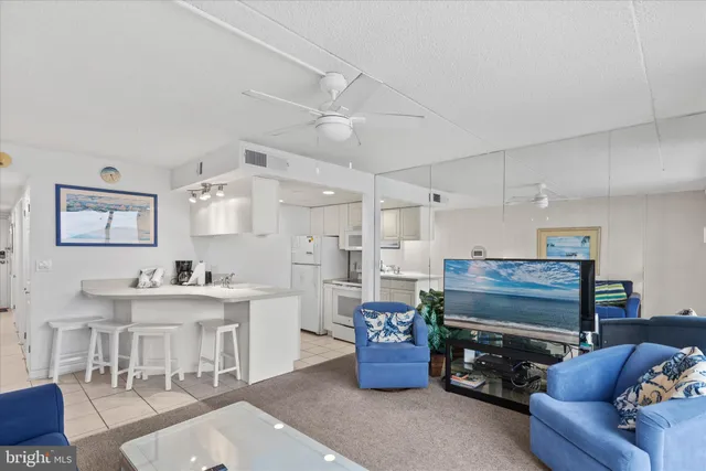 a living room with furniture a view of bedroom and a window