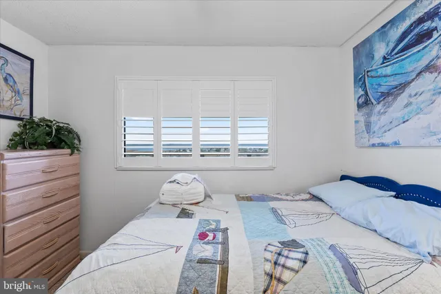 a view of walk in closet and bedroom