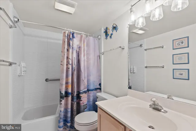 a bathroom with a shower curtain and a window