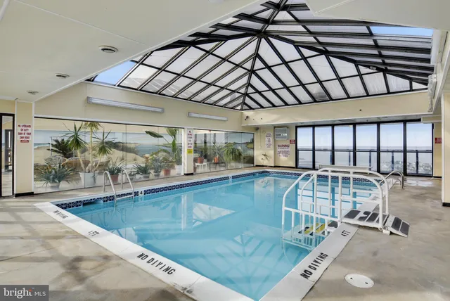 a room with pool table and windows