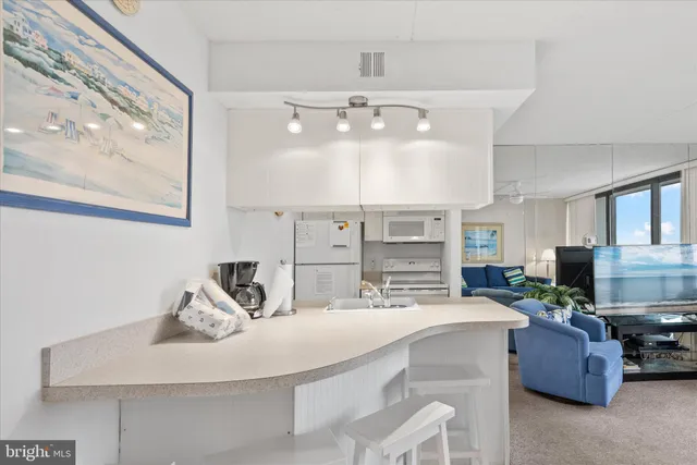 a kitchen with stainless steel appliances kitchen island granite countertop a sink and cabinets
