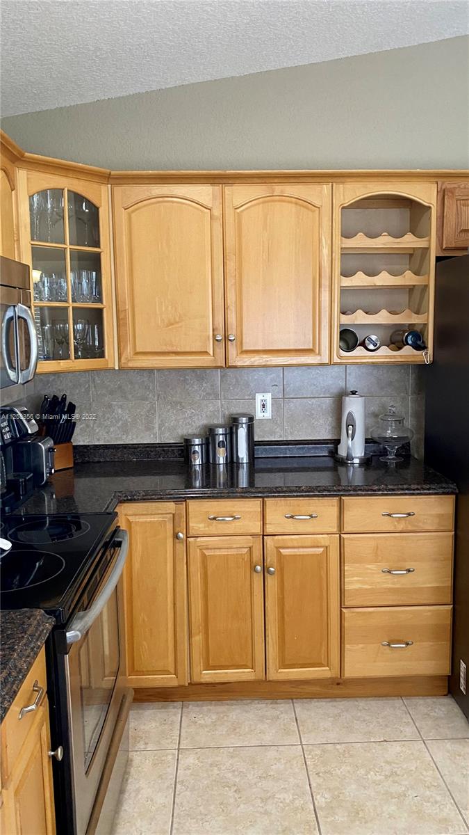 20309 Southwest 86th Court Cutler Bay, FL 33189 - Photo 13 of 59 a kitchen with stainless steel appliances granite countertop a stove and a sink