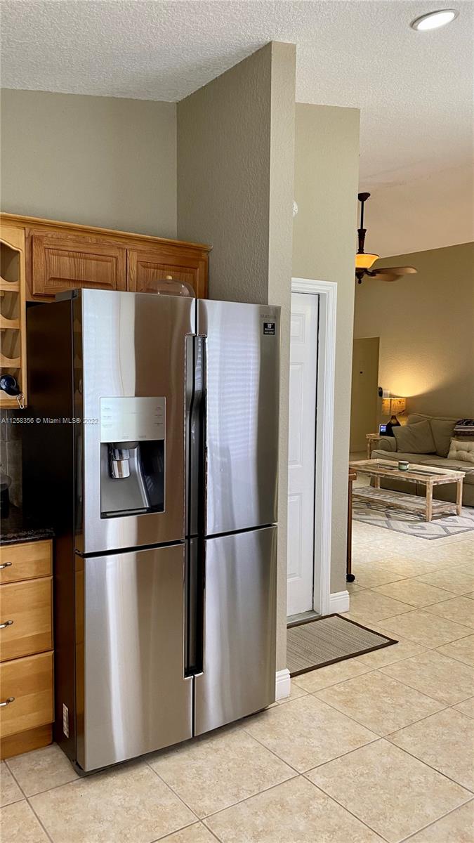 20309 Southwest 86th Court Cutler Bay, FL 33189 - Photo 16 of 59 a metallic refrigerator freezer sitting in a kitchen