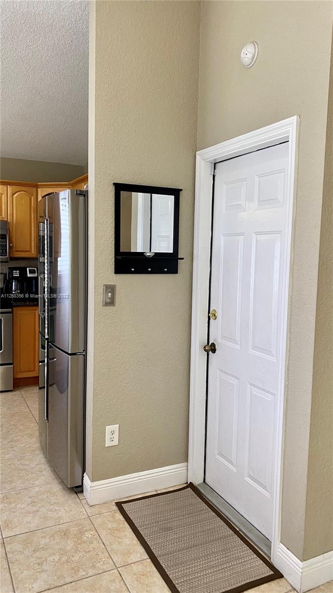 20309 Southwest 86th Court Cutler Bay, FL 33189 - Photo 17 of 59 a view of a refrigerator in kitchen and an empty room