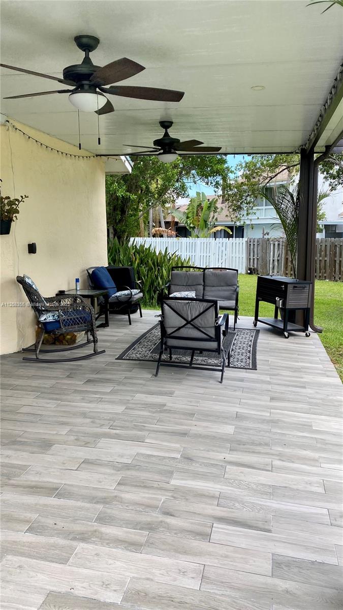 20309 Southwest 86th Court Cutler Bay, FL 33189 - Photo 19 of 59 a view of a patio with table and chairs potted plants with wooden floor