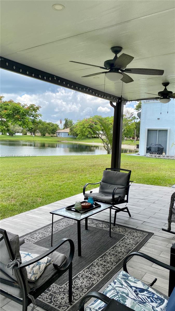 20309 Southwest 86th Court Cutler Bay, FL 33189 - Photo 20 of 59 a roof deck with table and chairs under an umbrella