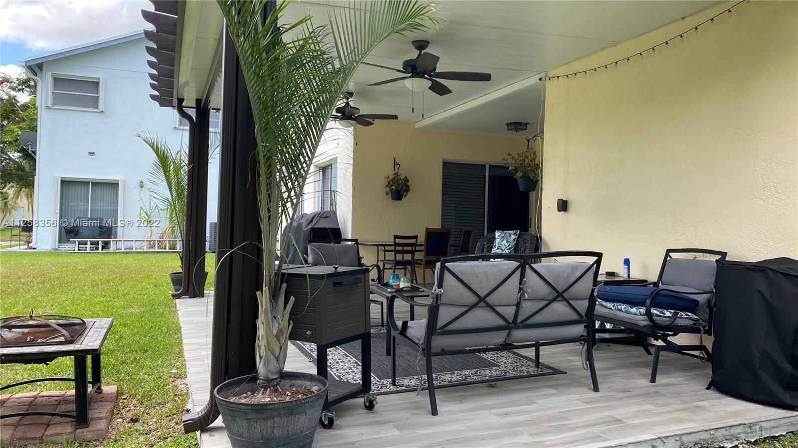 20309 Southwest 86th Court Cutler Bay, FL 33189 - Photo 25 of 59 a view of a patio with table and chairs and potted plants