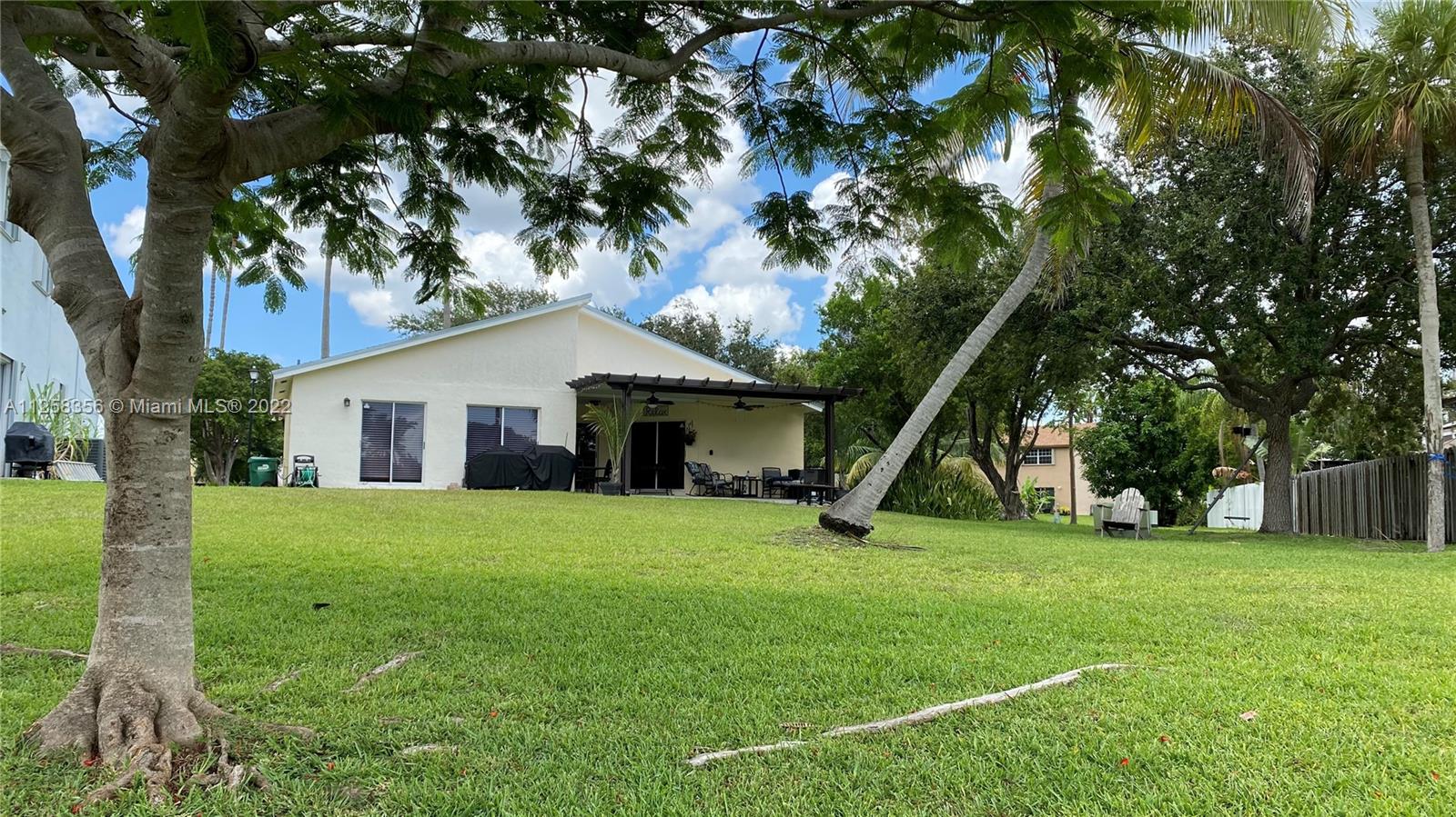 20309 Southwest 86th Court Cutler Bay, FL 33189 - Photo 26 of 59 a front view of house with a garden and trees