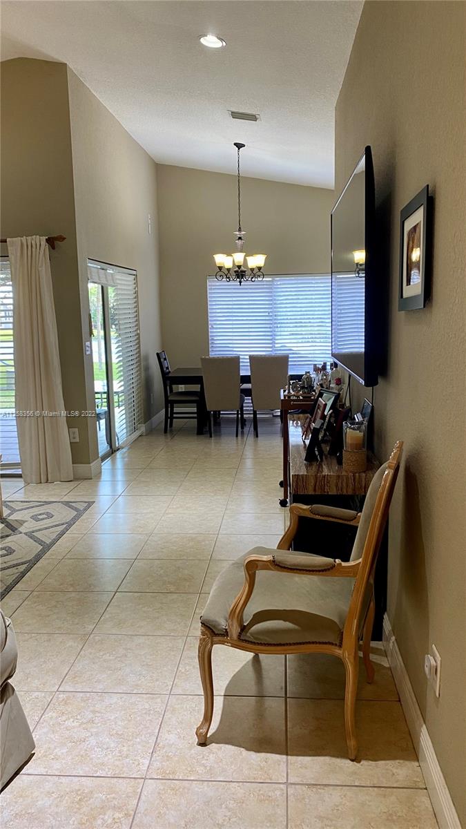 20309 Southwest 86th Court Cutler Bay, FL 33189 - Photo 3 of 59 a dining room with furniture and a chandelier