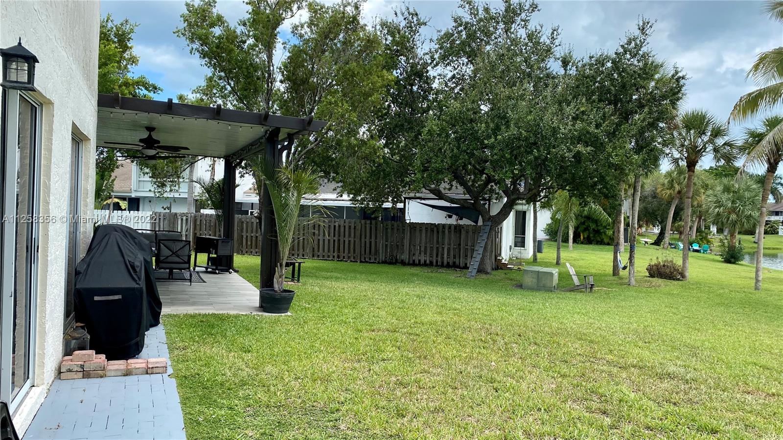 20309 Southwest 86th Court Cutler Bay, FL 33189 - Photo 33 of 59 a view of a backyard with a slide