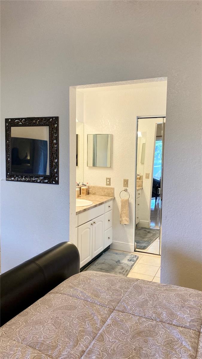 20309 Southwest 86th Court Cutler Bay, FL 33189 - Photo 39 of 59 a room with a bed and a view of bathroom