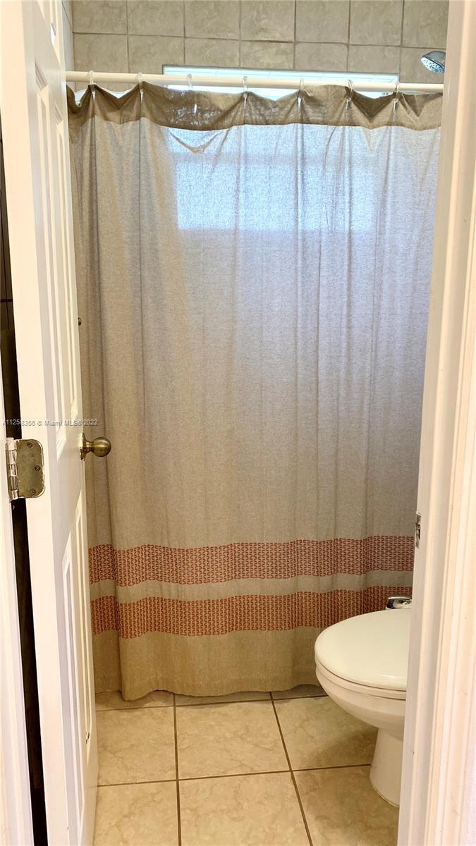 20309 Southwest 86th Court Cutler Bay, FL 33189 - Photo 42 of 59 a bathroom with a toilet and shower