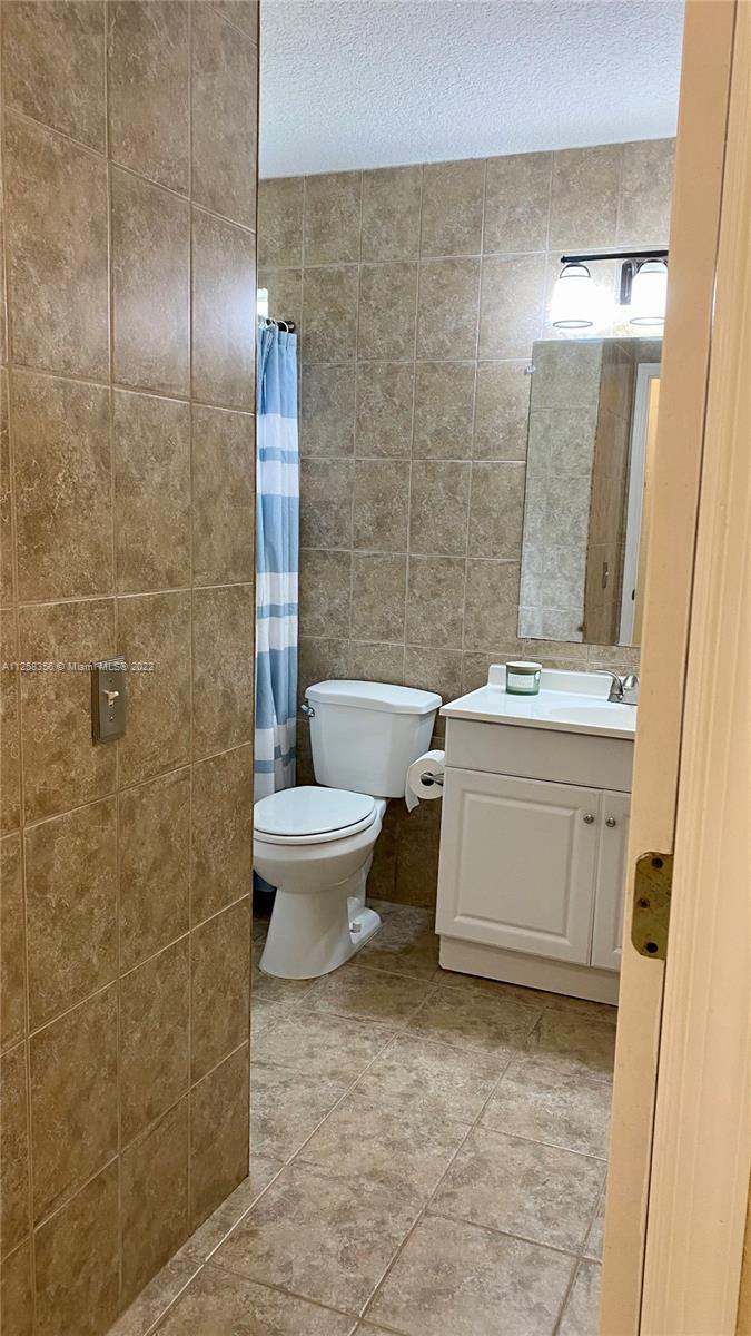 20309 Southwest 86th Court Cutler Bay, FL 33189 - Photo 44 of 59 a bathroom with a toilet sink and mirror
