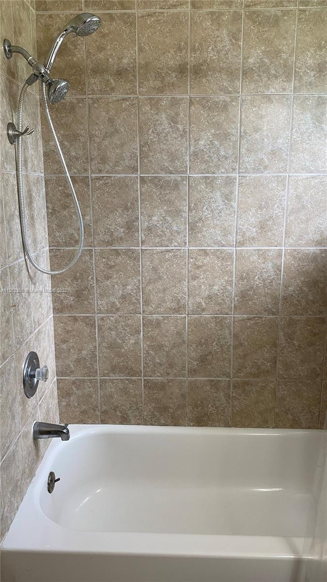 20309 Southwest 86th Court Cutler Bay, FL 33189 - Photo 47 of 59 a bathroom with a bathtub and a shower